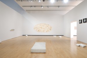 Installation view that focuses on what appears to be a cheap and well-worn mattress, but it is hand-carved from white marble